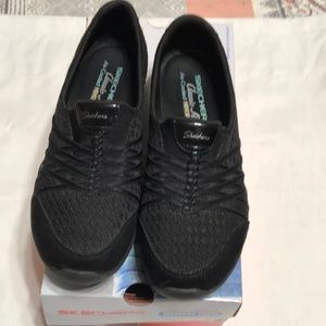 Sketchers black slip on tennis shoes. Size 8.5.